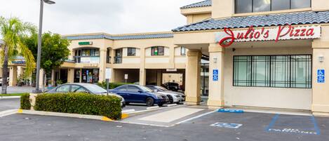 A parking lot with a building labeled "Julio's Pizza" in the background.