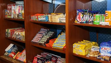 A snack display with various packaged snacks and a price tag for chips.
