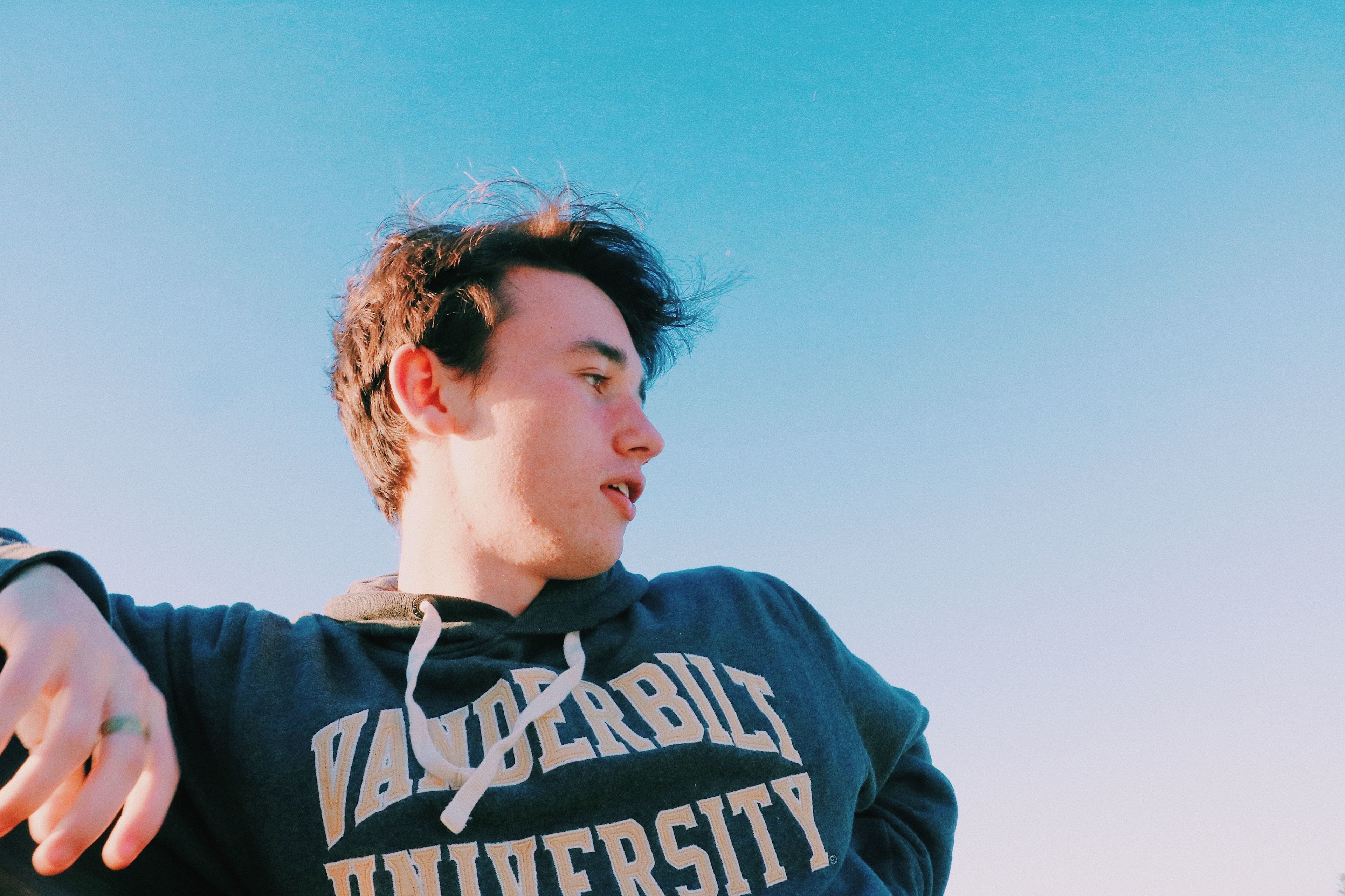 A person wearing a hoodie with "Vanderbilt University" printed on it.
