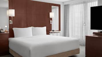 Premium bedding, desk, laptop workspace, blackout drapes