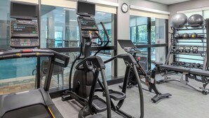 A gym with treadmills, elliptical machines, and a weight rack. - Courtyard by Marriott Pittsburgh Greensburg (Greensburg)
