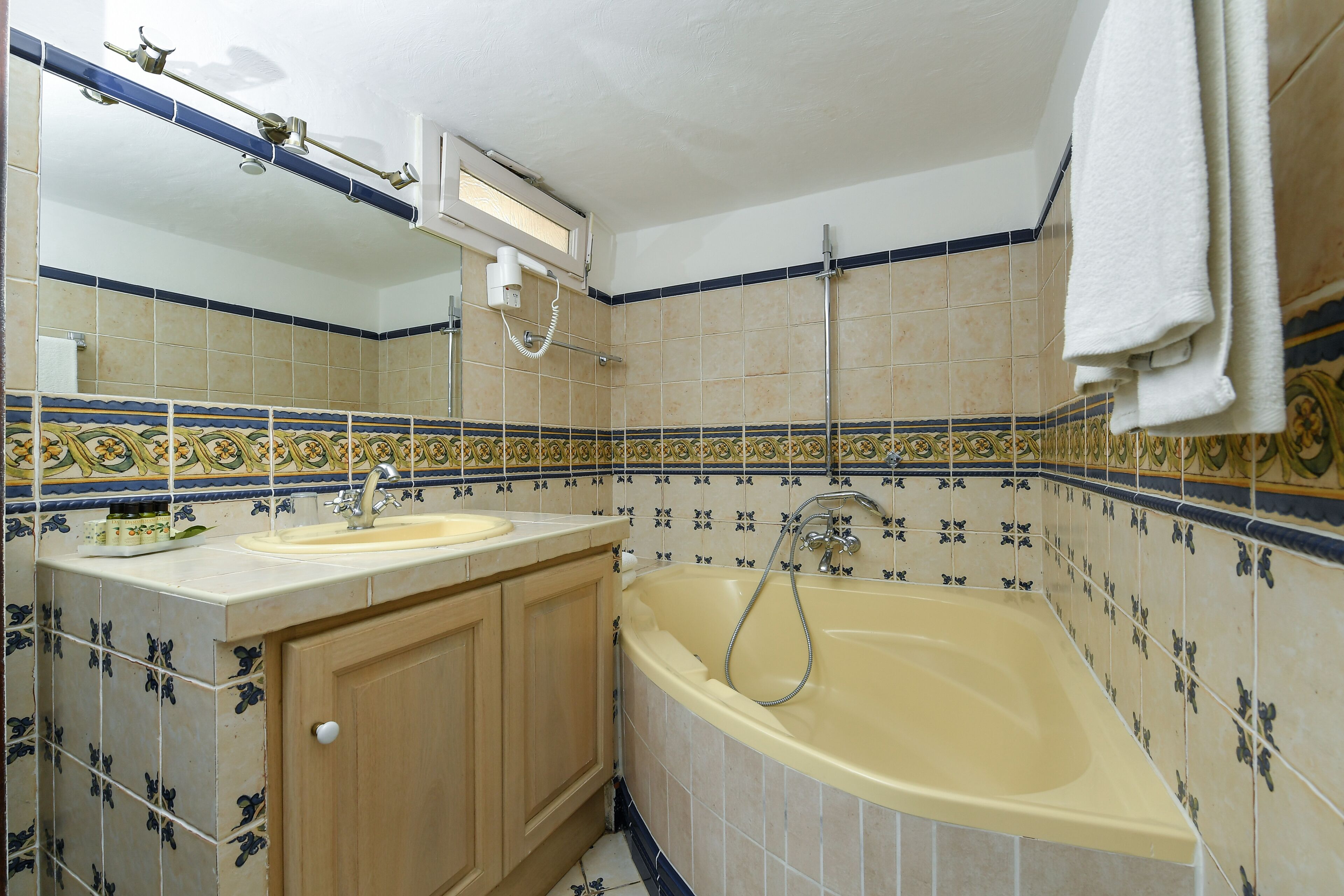 A bathroom with a bathtub, sink, and vanity.