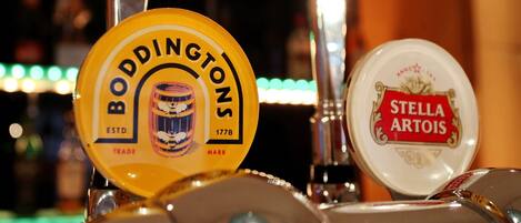 Two beer taps with labels, one for Boddingtons and the other for Stella Artois.