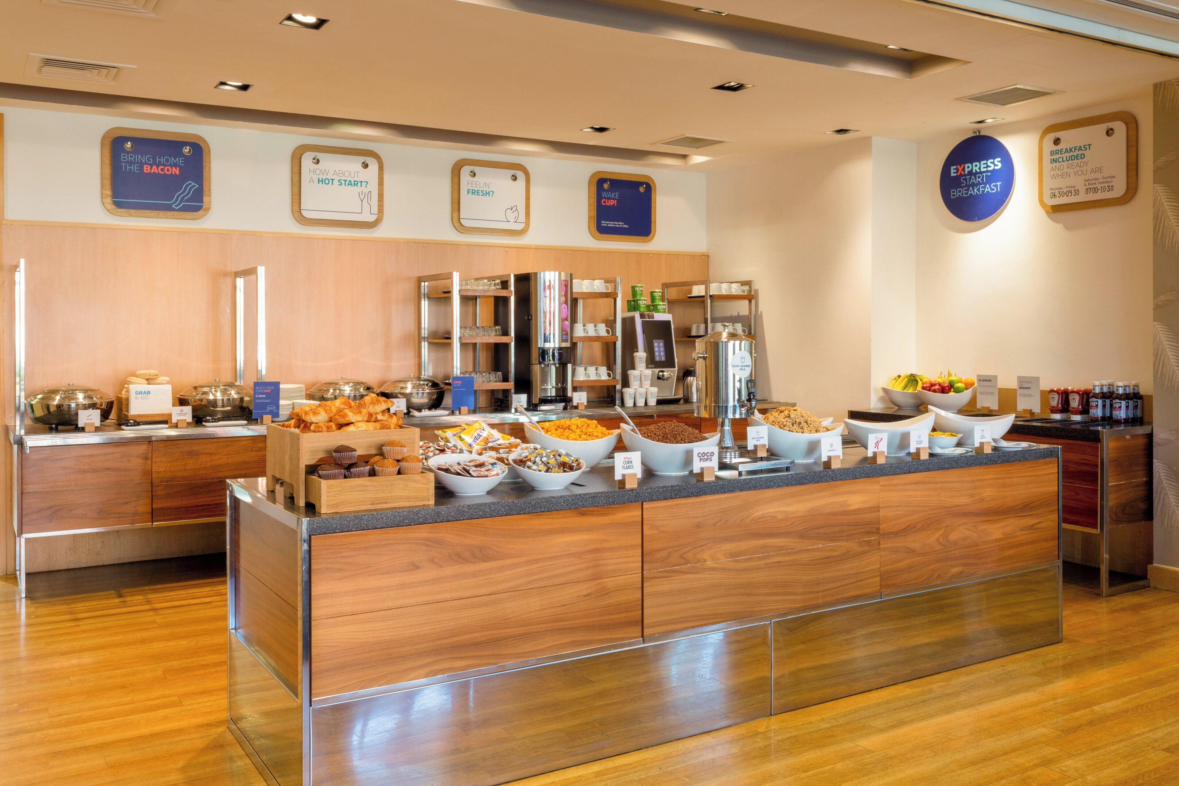 A buffet area with various food options and a coffee station.
