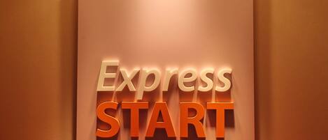 A wall-mounted sign with the words 'Express START' in white and orange letters.