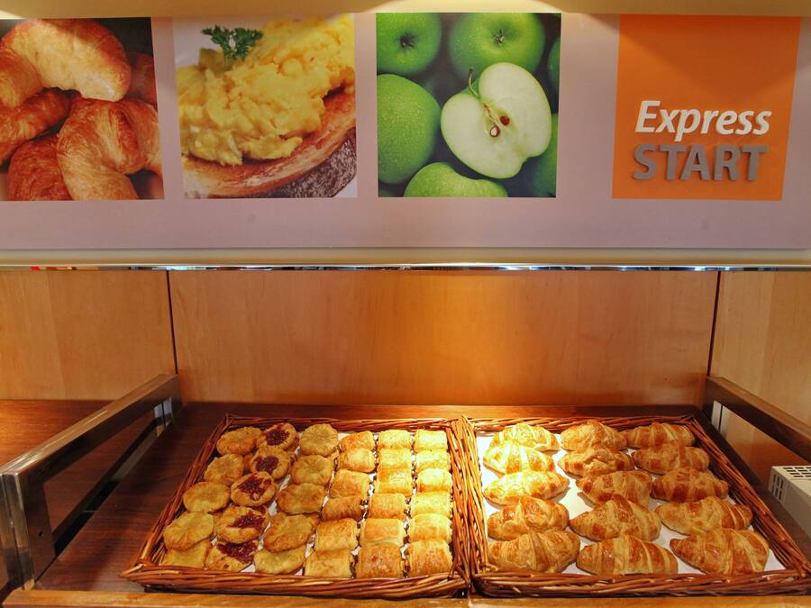 A bakery display with various pastries and a sign above reading 'Express START'.