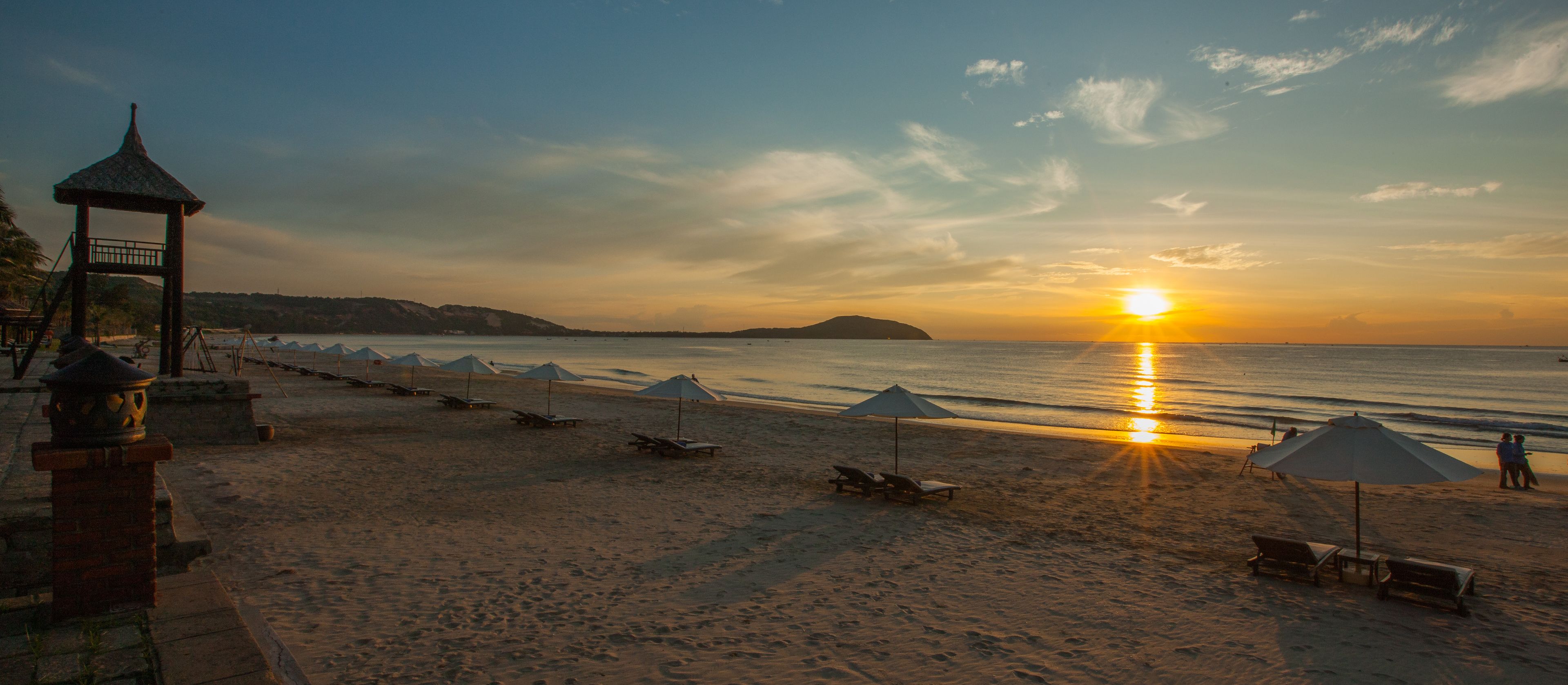 On the beach, white sand, sun loungers, beach umbrellas