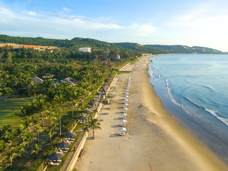 On the beach, white sand, sun-loungers, beach umbrellas