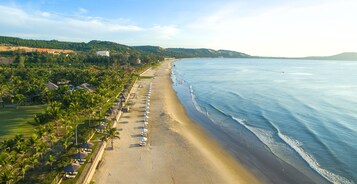 On the beach, white sand, sun loungers, beach umbrellas