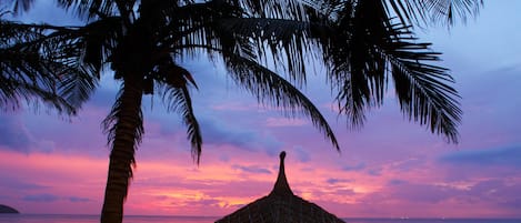 On the beach, white sand, sun loungers, beach umbrellas