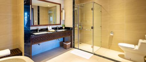 A modern bathroom with a glass-enclosed shower, a large mirror, and a bathtub.