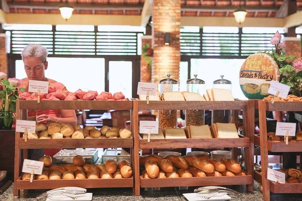 A bakery display with various breads and pastries.