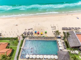 On the beach, white sand, sun loungers, beach umbrellas
