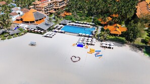 On the beach, white sand, sun-loungers, beach umbrellas