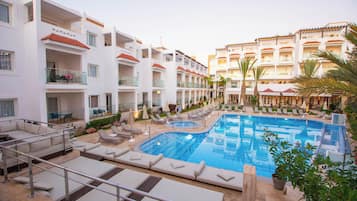 Relax by the rooftop pool surrounded by lounge chairs and sunbeds.