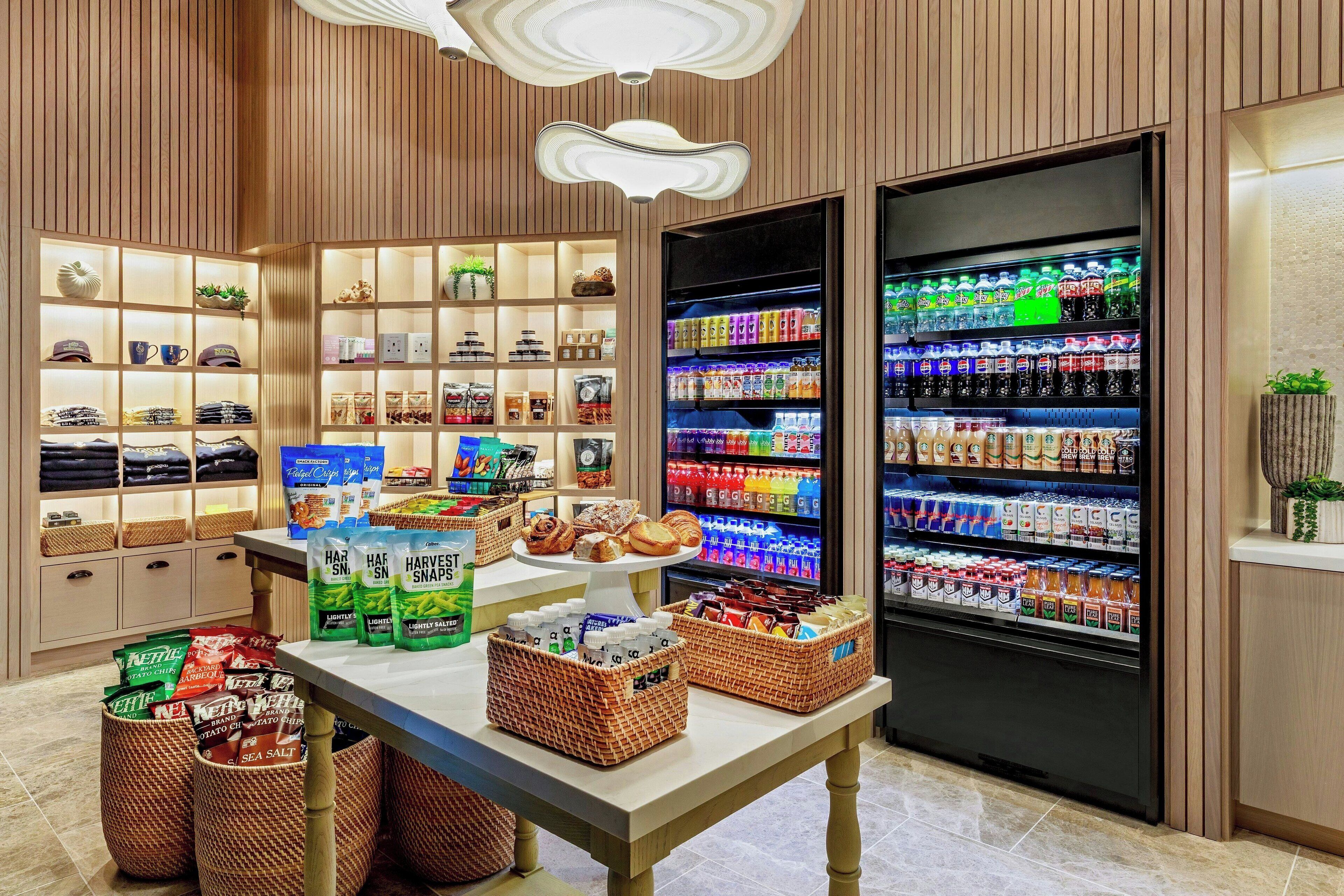 A well-lit store with shelves of snacks, beverages, and packaged goods.