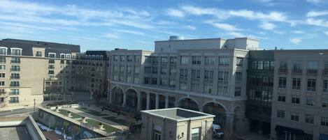 A multi-story building with a central courtyard, surrounded by other buildings.