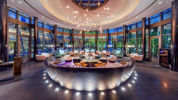 A modern lobby with a central seating area, large windows, and a unique ceiling design. - Shanghai Zhangjiang Parkyard Hotel (Shanghai)