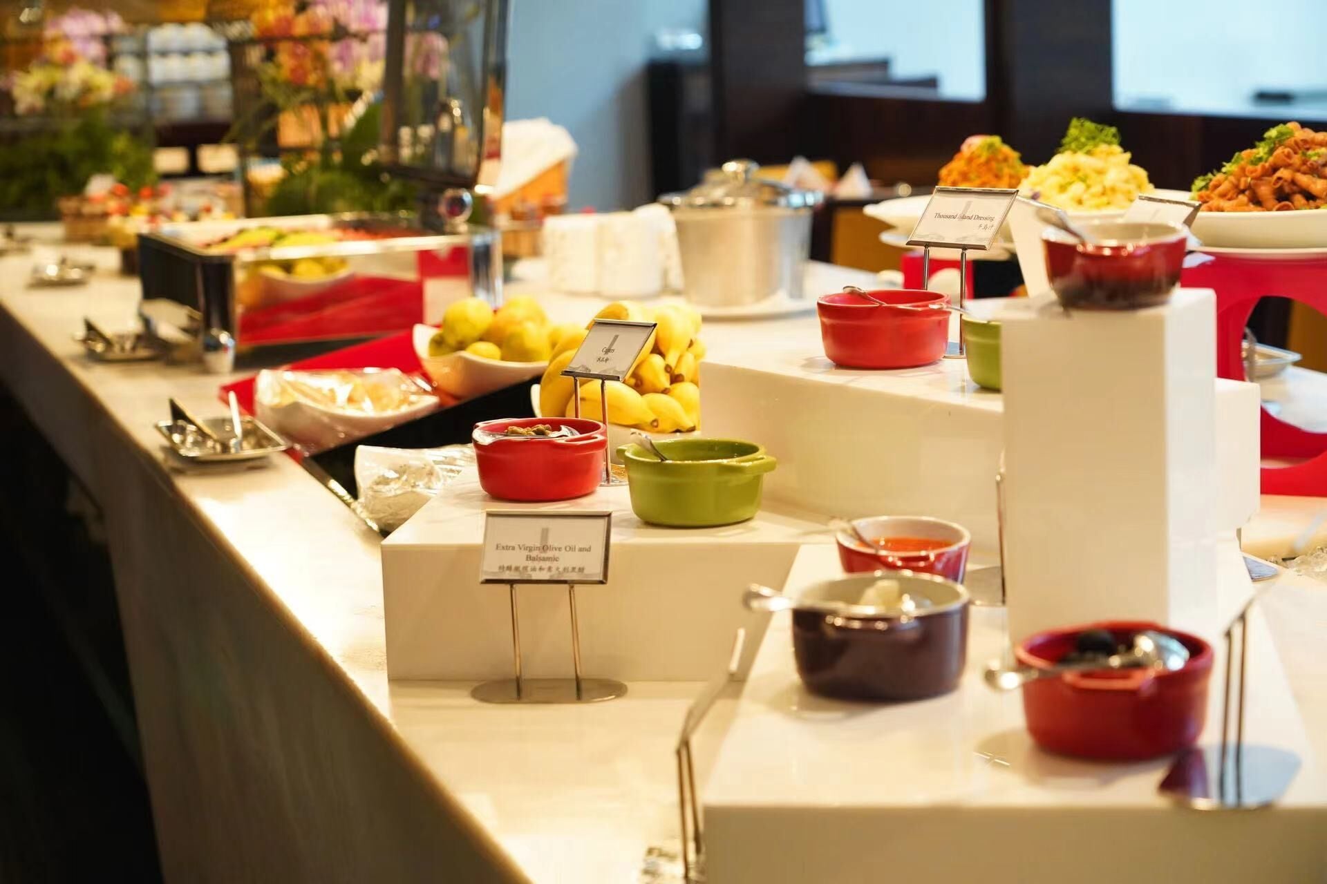 A buffet with various food items and condiments.