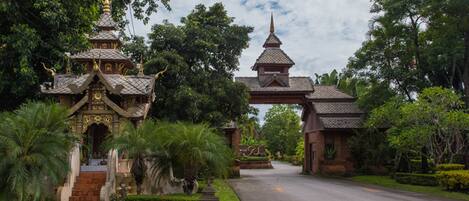 A traditional temple with a multi-tiered roof and a large gate.