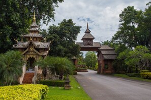 A traditional temple with a multi-tiered roof and a large gate.