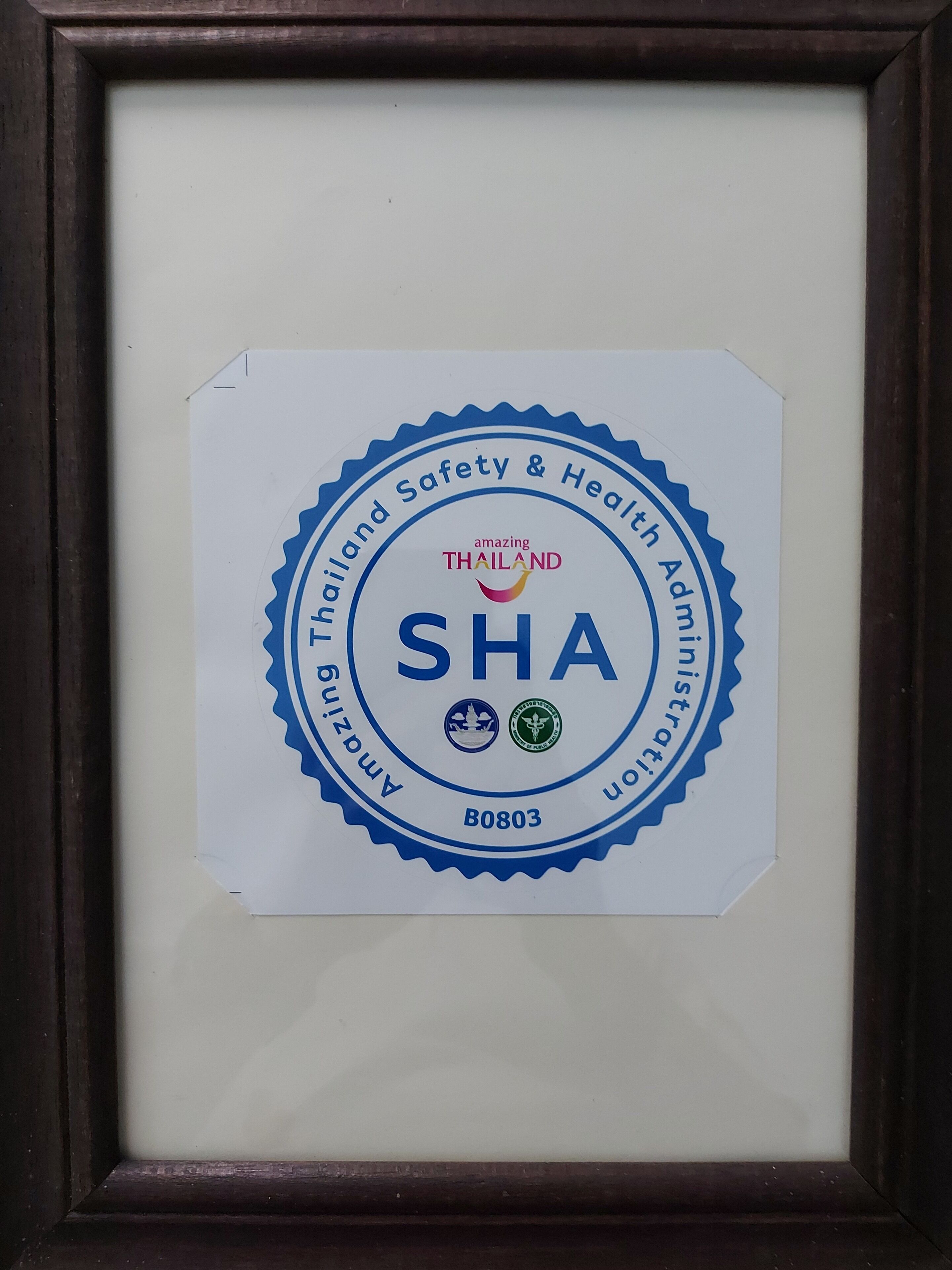 A framed certificate with the text "Thailand Safety & Health Administration" and "SHA" in the center.