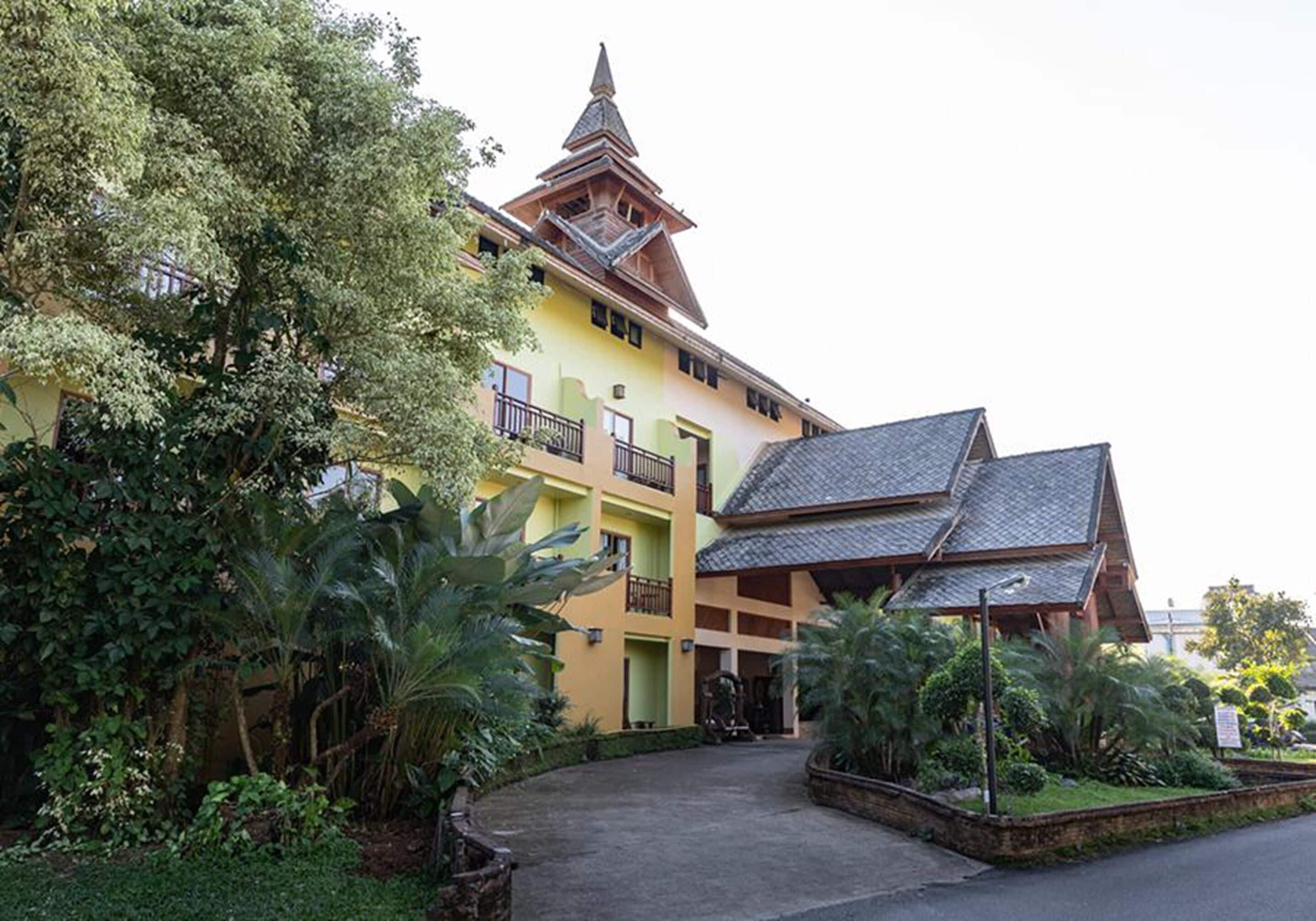 A multi-story building with a traditional architectural style, featuring a prominent tower and multiple balconies.