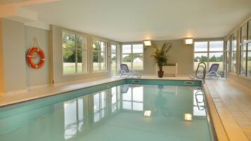 Indoor pool, open 8:00 AM to 7:00 PM, pool loungers