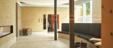 A modern interior with a seating area, a fireplace, and a view of the outdoors.