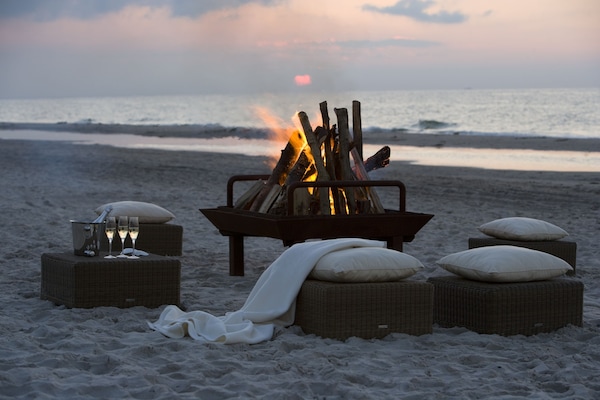 On the beach, white sand, sun-loungers, beach towels