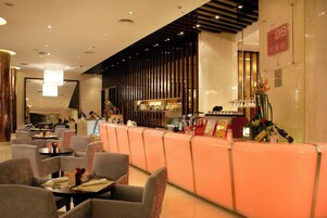 A modern lounge area with seating and a bar.