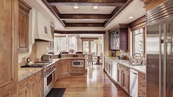 A spacious kitchen with wooden cabinets, stainless steel appliances, and a large island.