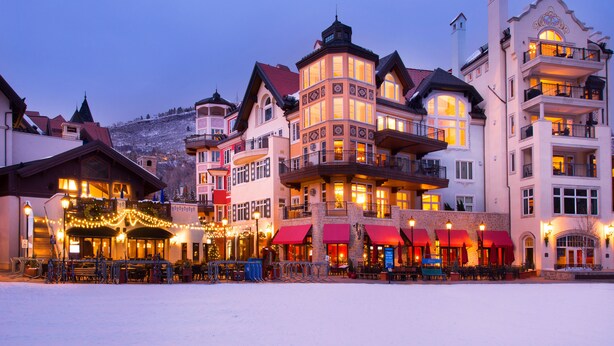 A hotel with multiple stories, balconies, and a snow-covered ground. - The Arrabelle, A RockResort, by Vail Resorts (Vail)