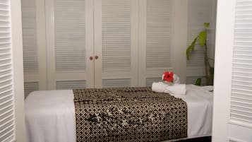 Comfortable retreat with a neatly made bed, ample closet space, and a touch of greenery.