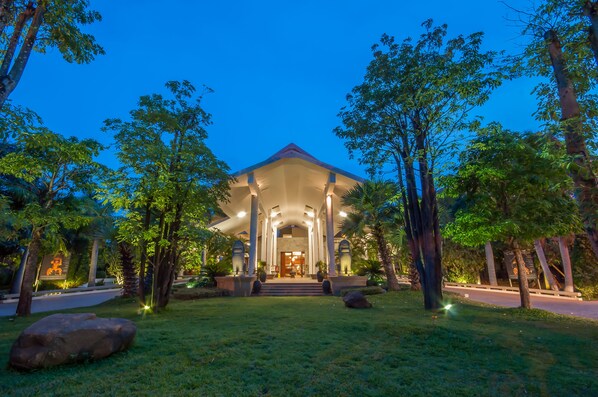 A building with a symmetrical facade, large columns, and a central entrance.