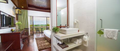 A modern bathroom with a large mirror, a sink, and a shower.
