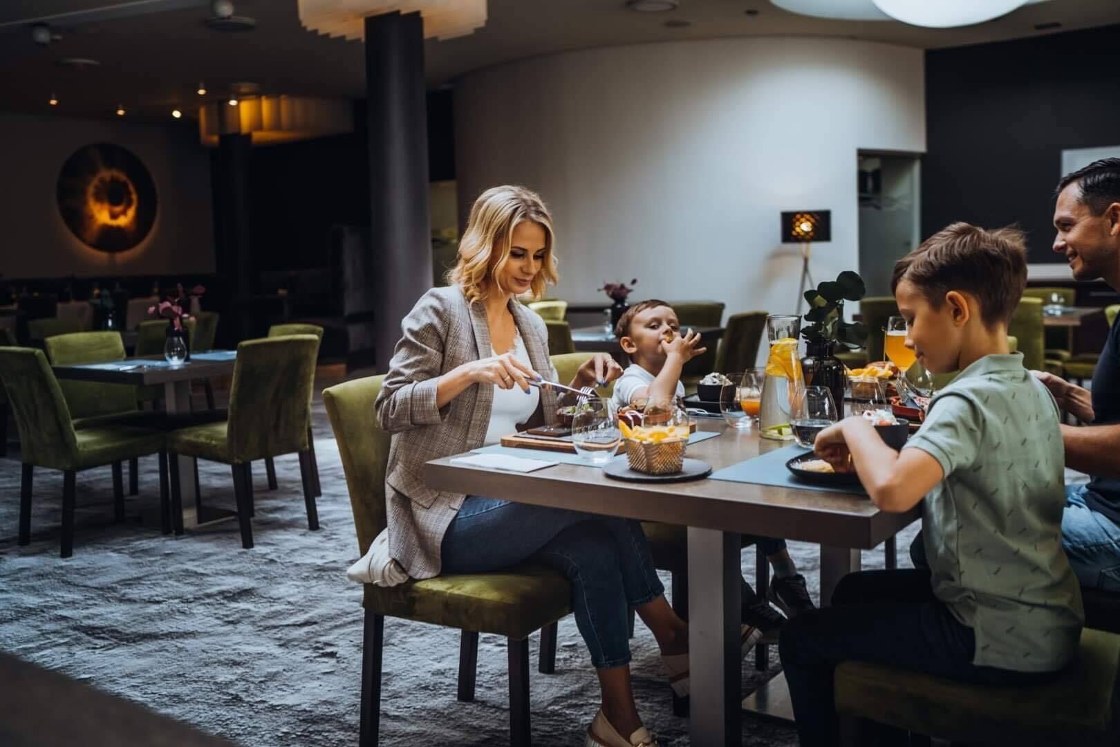 A dining area with round tables, chairs, and a modern interior design.