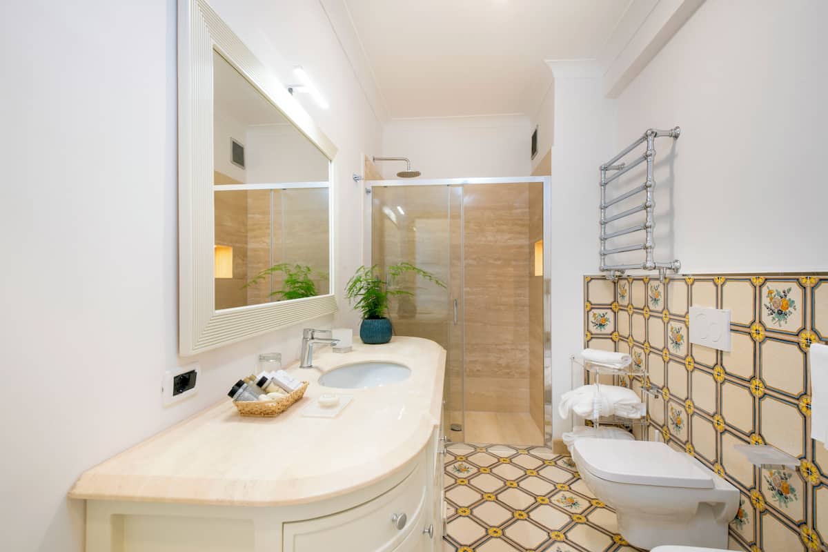 superior double room | bathroom | shower, hair dryer, slippers, towels