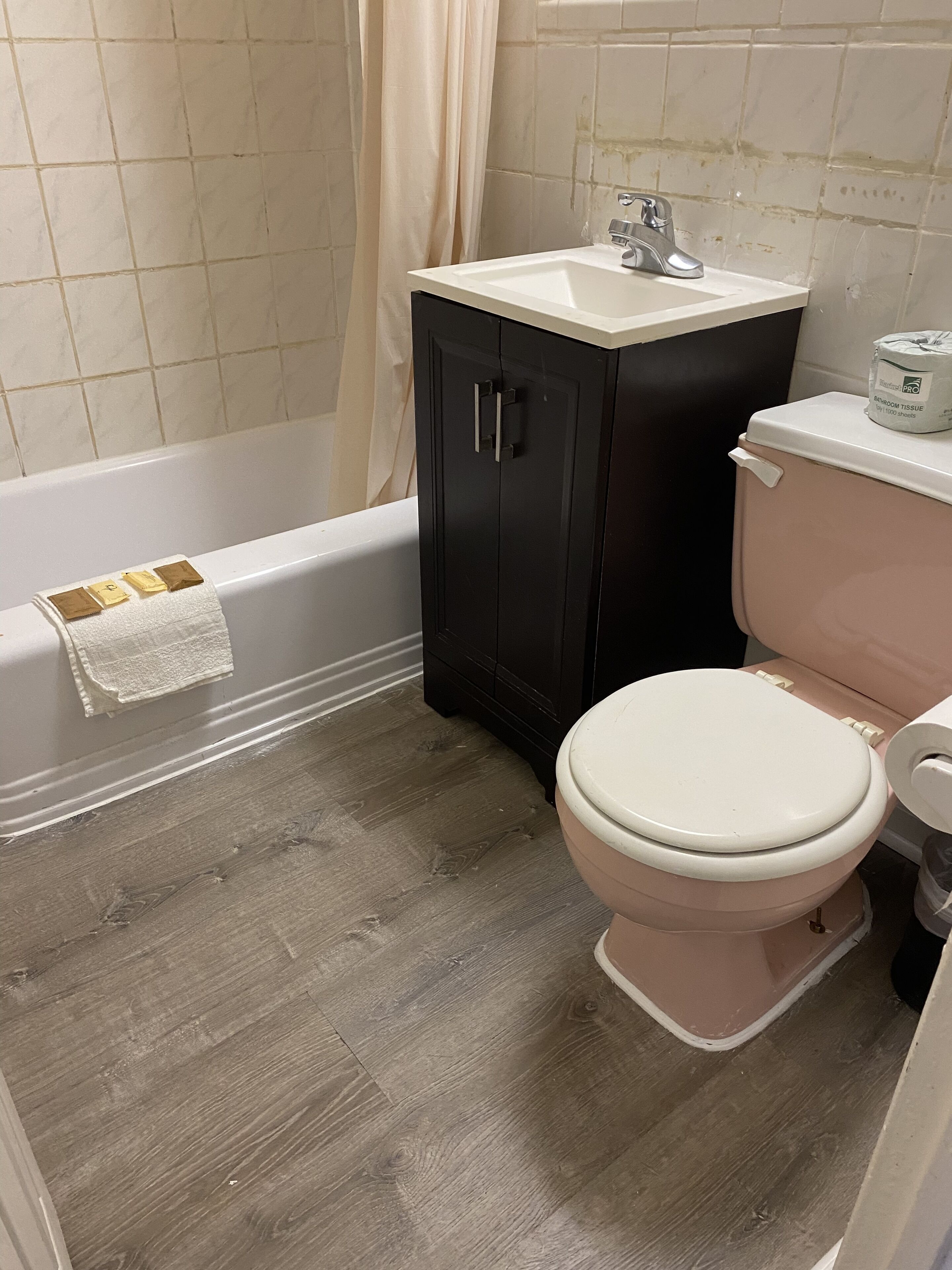 A bathroom with a bathtub, a toilet, and a sink.