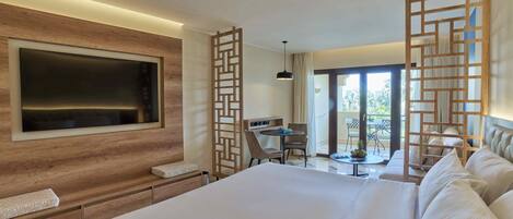 A modern hotel room with a large bed, a TV mounted on the wall, a desk with a chair, and a balcony with a view.