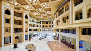 A multi-level atrium with a central open space, multiple balconies, and a reception area. - Steigenberger ALDAU Beach Hotel (Hurghada)