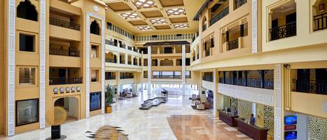 A multi-level atrium with a central open space, multiple balconies, and a reception area.