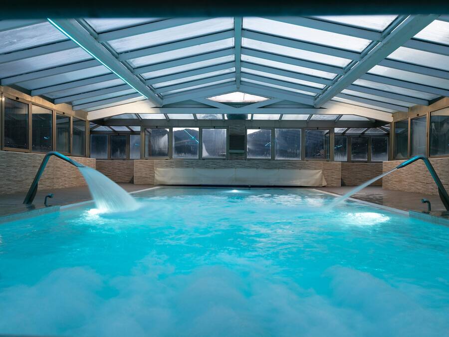 Indoor pool, open 11:00 AM to 8:00 PM, pool loungers