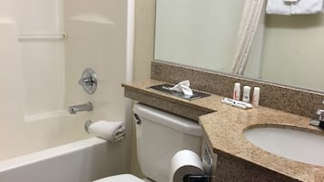 A bathroom with a toilet, sink, and bathtub.