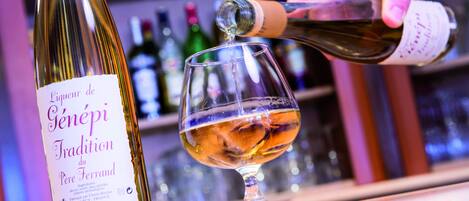 A bottle of wine being poured into a glass.