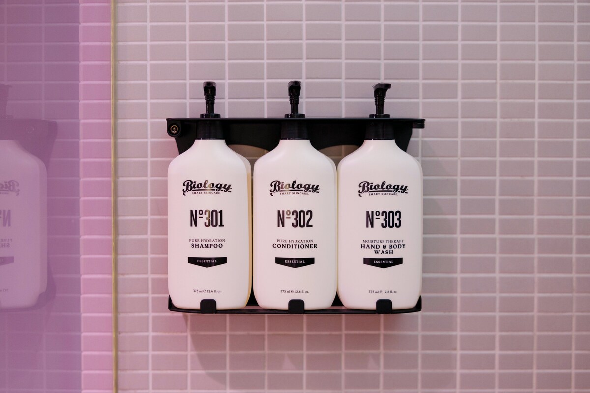 Three bottles of Biology skincare products on a shelf.