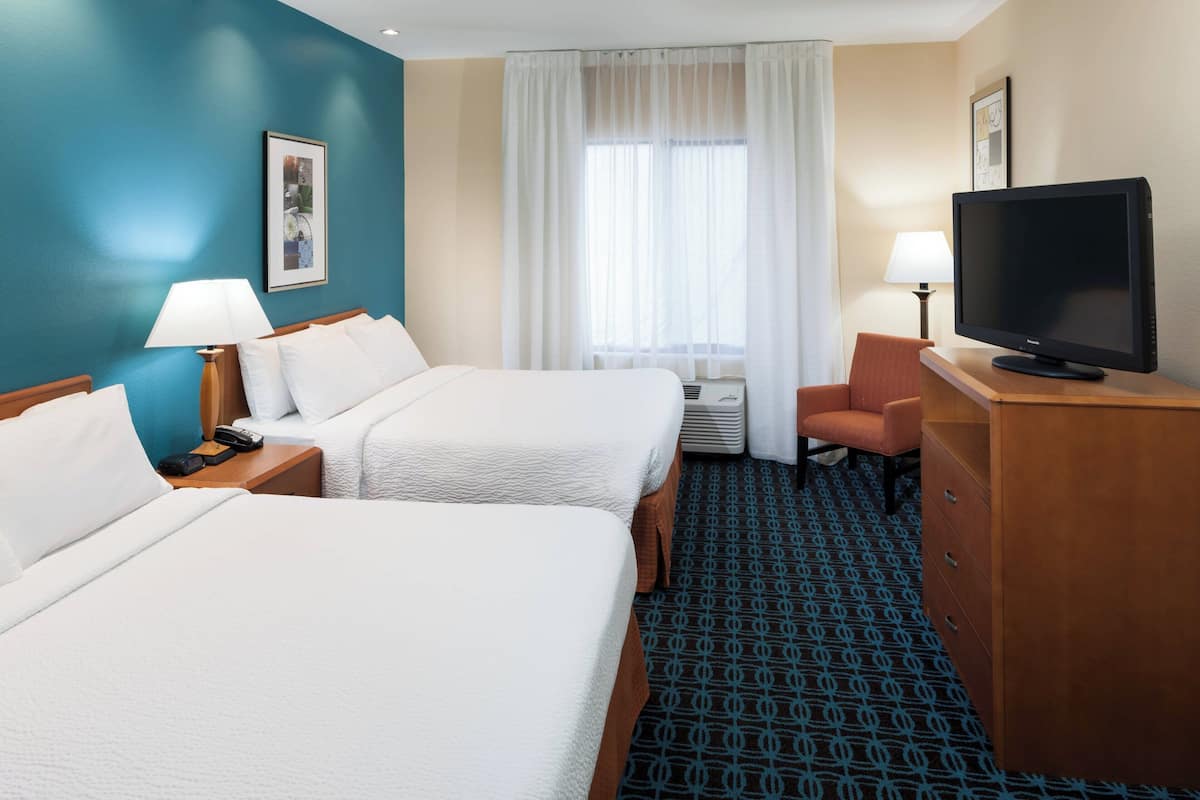 Hypo-allergenic bedding, desk, laptop workspace, blackout drapes