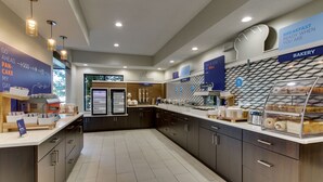 A modern breakfast area with a bakery section, yogurt and egg station, and a sign indicating a bakery. - Holiday Inn Express Fishkill-Mid Hudson Valley by IHG (Fishkill)