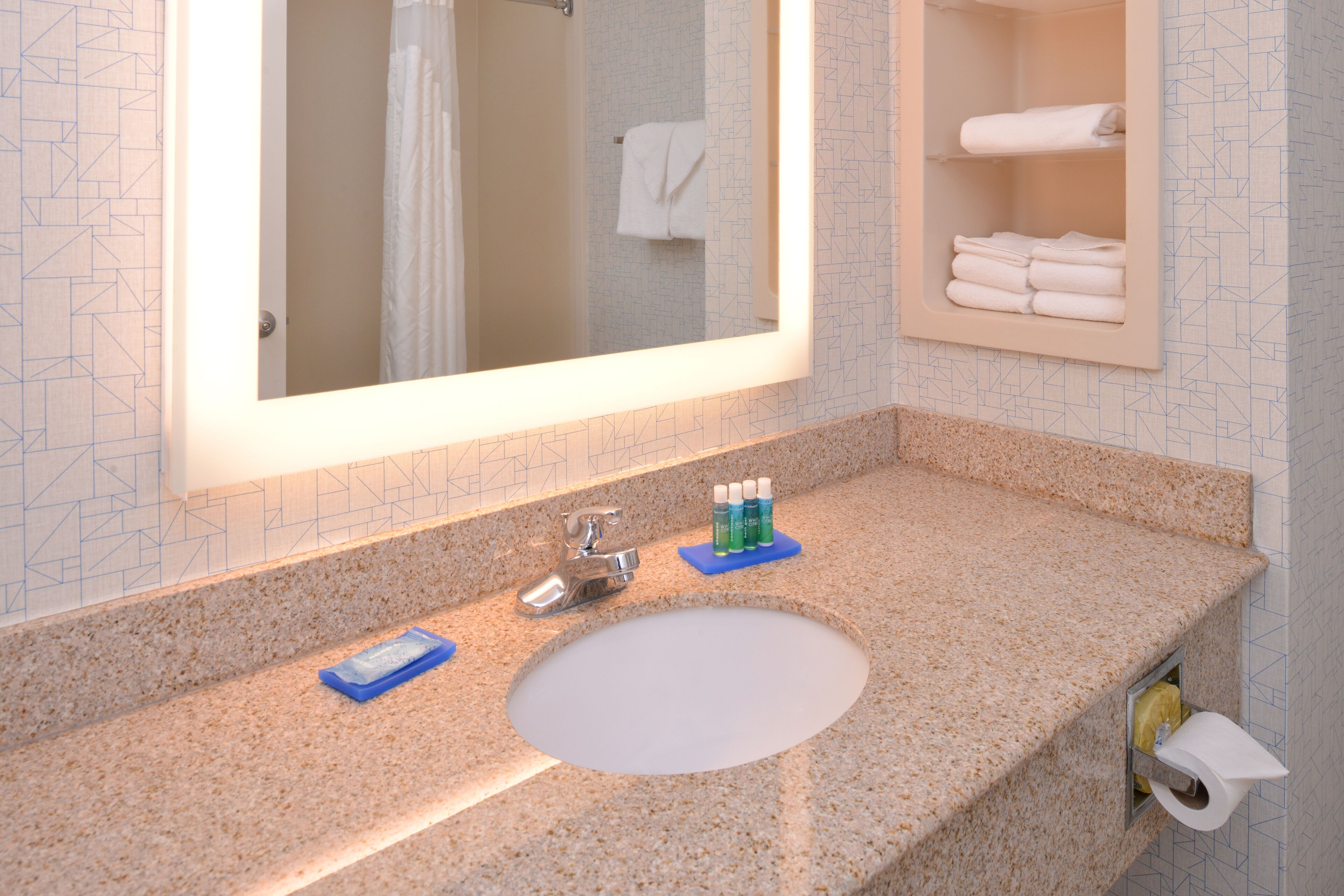 designer toiletries, hair dryer, towels