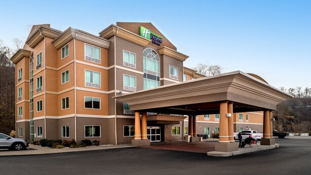 A Holiday Inn Express building with a covered entrance, multiple floors, and a parking lot.
